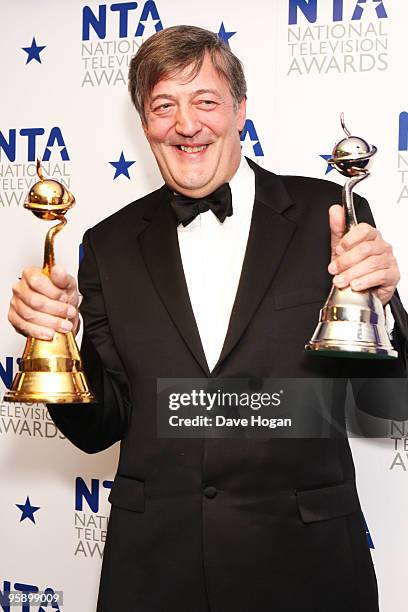 Stephen Fry poses with his most popular documentary and special recognition awards in the press room at the National Television Awards held the at...