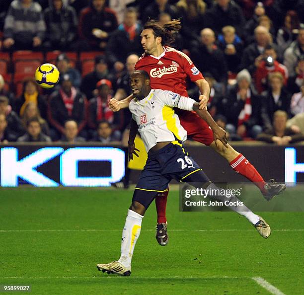 Sotirios Kyrgiakos of Liverpool goes up with Ledley King of Tottenham Hotspur during the Barclays Premier League match between Liverpool and...