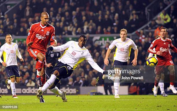 David Ngog of Liverpool is taken down in the area by Sebastian Bassong of Tottenham Hotspur for a penalty during the Barclays Premier League match...