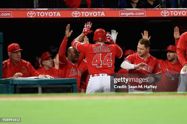 Manager Mike Scioscia, Justin Upton and Kole Calhoun congratulate Rene Rivera of the Los Angeles Angels of Anaheim after his solo homerun during the...