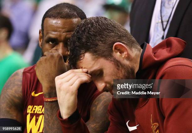 LeBron James and Kevin Love of the Cleveland Cavaliers react on the bench in the second half against the Boston Celtics during Game Two of the 2018...