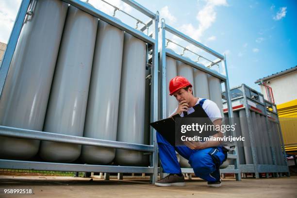 young engineer at work - fueling construction equipment stock pictures, royalty-free photos & images