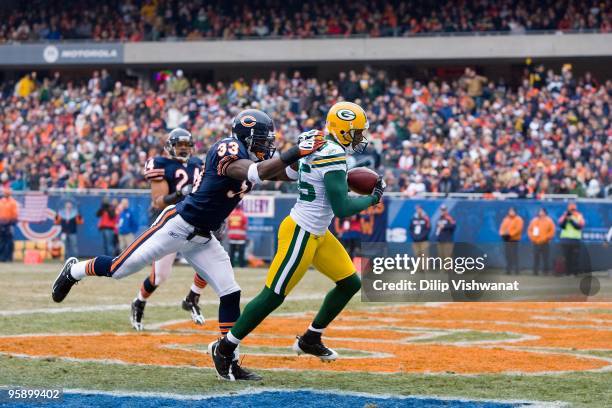 Greg Jennings of the Green Bay Packers attempts to make a catch against Charles Tillman of the Chicago Bears at Soldier Field on December 13, 2009 in...