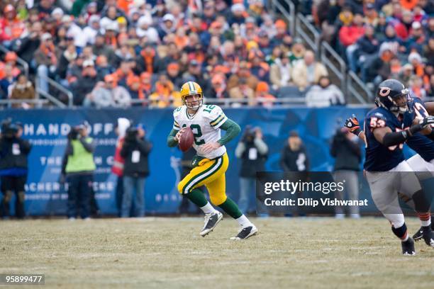 Aaron Rodgers of the Green Bay Packers scrambles against the Chicago Bears at Soldier Field on December 13, 2009 in Chicago, Illinois.