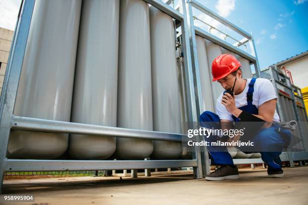 young engineer at work - fueling construction equipment stock pictures, royalty-free photos & images