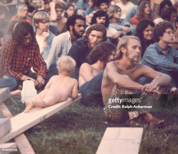 Crowd of people watching Hog Farmers' free stage show at the Woodstock Music Festival, Bethel, NY, 1969.