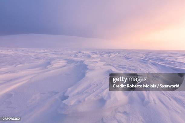 twilight on frozen landscape, lapland, finland - moutain sunset snow stock-fotos und bilder