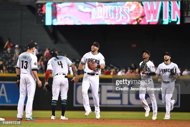 Nick Ahmed, Ketel Marte, David Peralta, Jarrod Dyson and Steven Souza Jr. #28 of the Arizona Diamondbacks celebrate after closing out the MLB game...