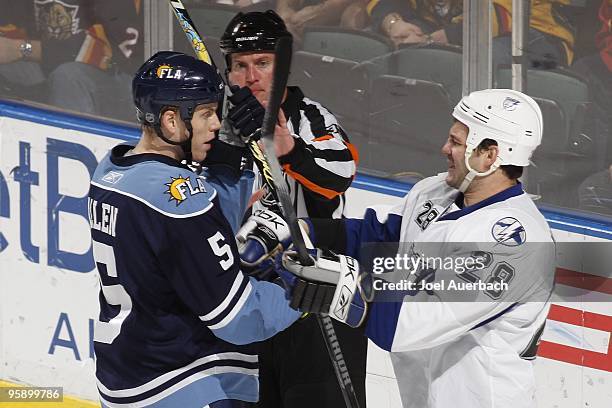 Referee Kevin Pollock separates Bryan Allen of the Florida Panthers and Zenon Konopka of the Tampa Bay Lightning on January 16, 2010 at the...