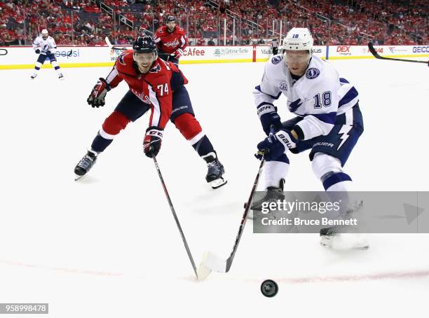 John Carlson of the Washington Capitals and Ondrej Palat of the Tampa Bay Lightning battle for the puck in Game Three of the Eastern Conference...