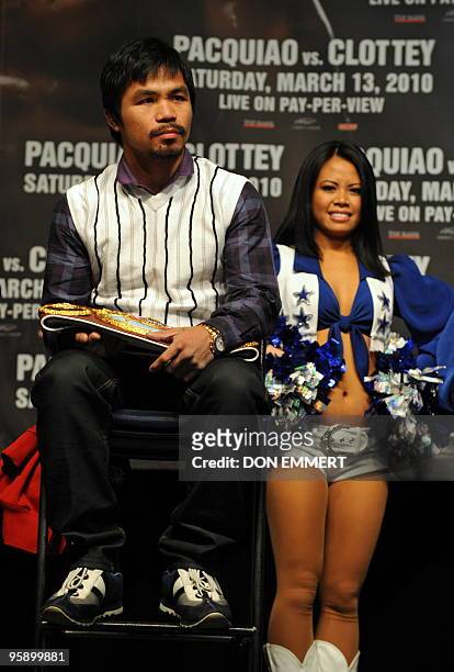 World champion boxer Manny �PacMan� Pacquiao stands with a Dallas Cowboy Cheerleader during a news conference January 20, 2010 in New York. The fight...