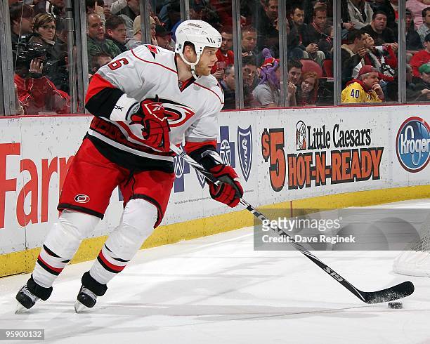 Tim Gleason of the Carolina Hurricanes turns up ice with the puck during a NHL game against the Detroit Red Wings at Joe Louis Arena on January 14,...