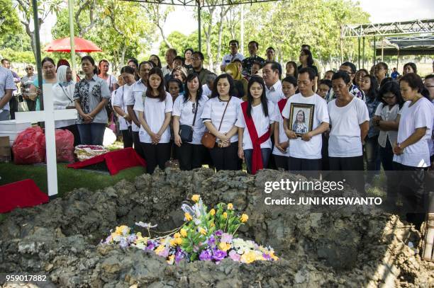 Relatives and friends of Martha Djumani, who died in a blast at the Pentekosta Church, attend her funeral in Surabaya on May 16, 2018. - Indonesia's...