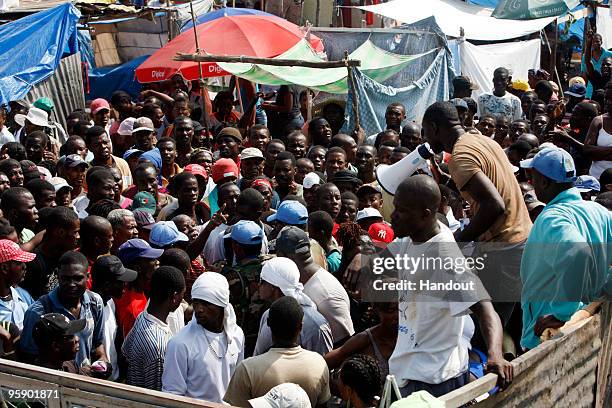 In this handout image provided by the United Nations Stabilization Mission in Haiti , UN personnel distribute water and vouchers for food coordinated...