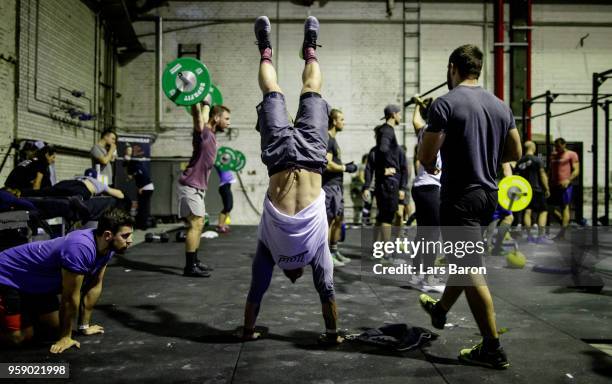 Kevin Winkens of Crossfit Vitus warms up with an handstand work during day two of the German Throwdown 2017 at Halle 45 on November 12, 2017 in...