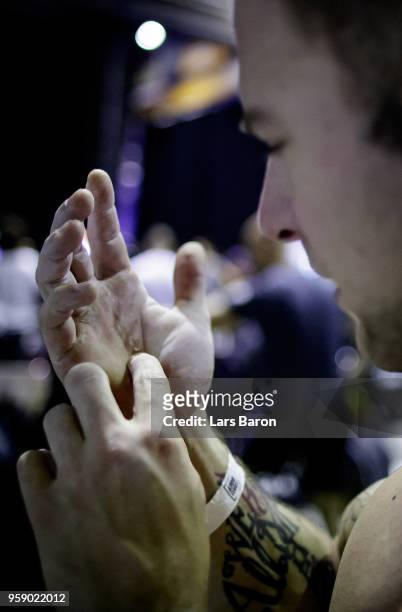 Kevin Winkens of Crossfit Vitus checks his hands after a workout during day two of the German Throwdown 2017 at Halle 45 on November 12, 2017 in...