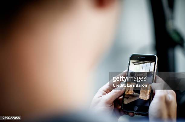 Kevin Winkens of Crossfit Vitus checks a video on his phone during a training session on October 16, 2017 in Moenchengladbach, Germany. Winkens...