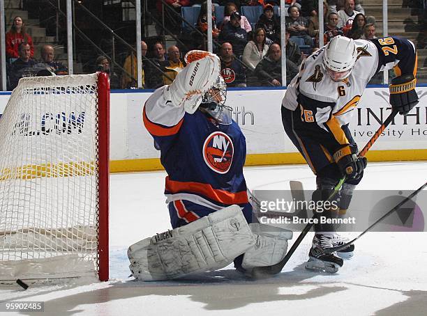 Rick DiPietro of the New York Islanders tends net against Tomas Vanek of the Buffalo Sabres at the Nassau Coliseum on January 16, 2010 in Uniondale,...