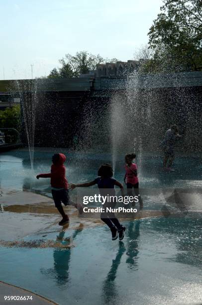 Children play at a sprayground as severe weather builds up, in Philadelphia, PA, on Primary Election Day, May 15, 2018.