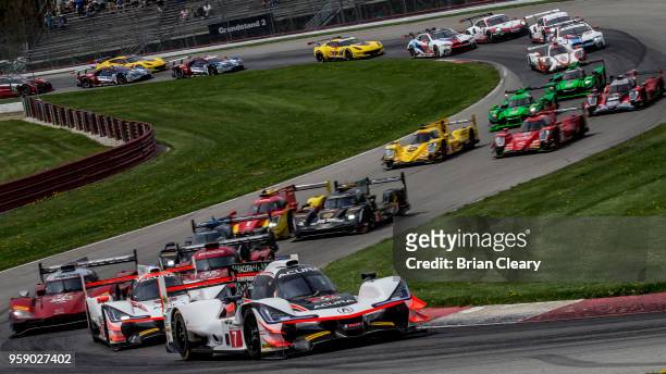The Acura DPi of Ricky Taylor and Helio Castroneves, of Brazil, leads the field through a curvy part of the track during the Acura Sports Car...