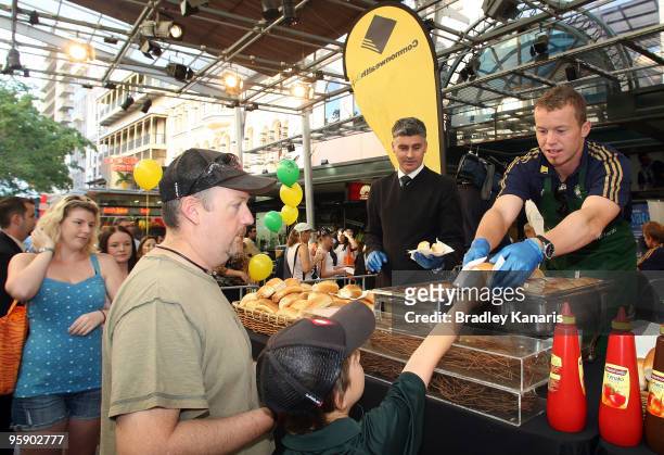 Peter Siddle serves up breakfast to fans during the Commonwealth Bank One Day International Series launch in the Queen Street Mall on January 21,...