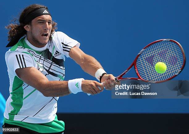 Juan Monaco of Argentina plays a backhand in his second round match against Michael Llodra of France during day four of the 2010 Australian Open at...