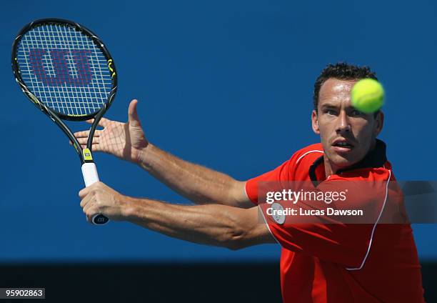 Michael Llodra of France plays a backhand in his second round match against Juan Monaco of Argentina during day four of the 2010 Australian Open at...