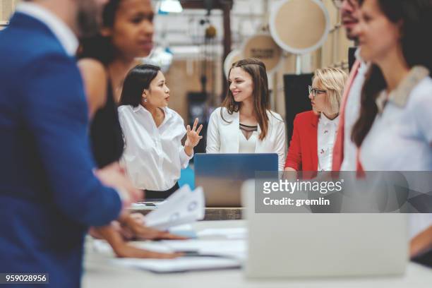 group of business people in the office meeting - bustling office stock pictures, royalty-free photos & images