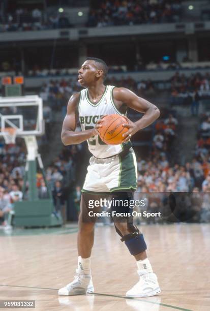 Jeff Grayer of the Milwaukee Bucks looks to pass the ball during an NBA basketball game circa 1990 at the Bradley Center in Milwaukee, Wisconsin....