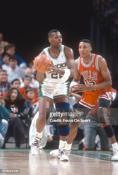Jeff Grayer of the Milwaukee Bucks looks to pass the ball while guarded by Scottie Pippen of the Chicago Bulls during an NBA basketball game circa...