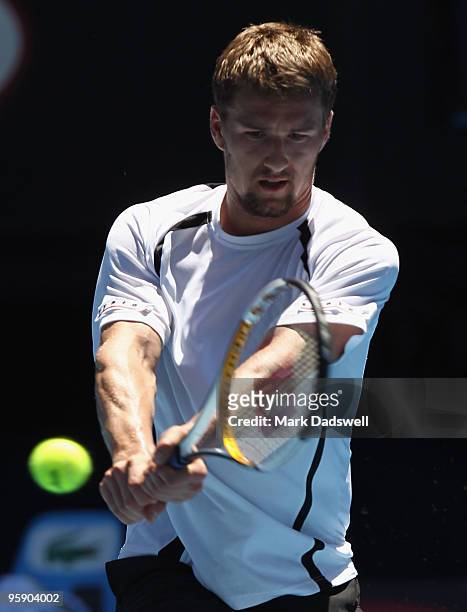 Marco Chiudinelli of Switzerland plays a backhand in his second round match against Novak Djokovic of Serbia during day four of the 2010 Australian...