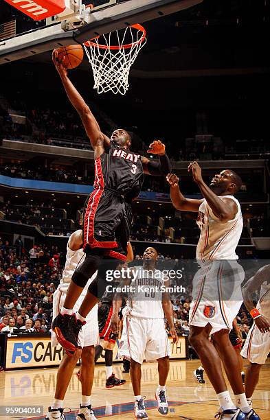 Dwyane Wade of the Miami Heat blocks against DeSagana Diop of the Charlotte Bobcats on January 20, 2010 at the Time Warner Cable Arena in Charlotte,...