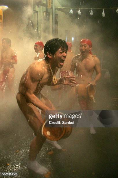 Men splash hot water each other during the Yukake Festival at Kawarayu hot spring district on January 20, 2010 in Naganohara, Gunma, Japan. 60 men...