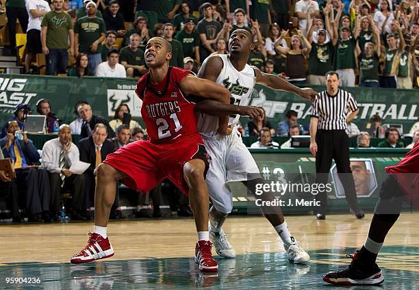 Toarlyn Fitzpatrick of the South Florida Bulls battles Austin Johnson of the Rutgers Scarlet Knights for position during the game at the SunDome on...