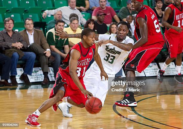 Mike Coburn of the Rutgers Scarlet Knights drives against Mike Mercer of the South Florida Bulls during the game at the SunDome on January 16, 2010...