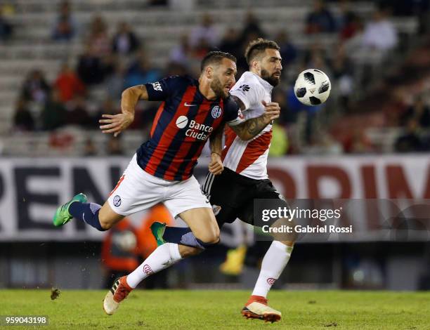 Lucas Pratto of River Plate fights for the ball with Gonzalo Rodriguez of San Lorenzo during a match between River Plate and San Lorenzo as part of...