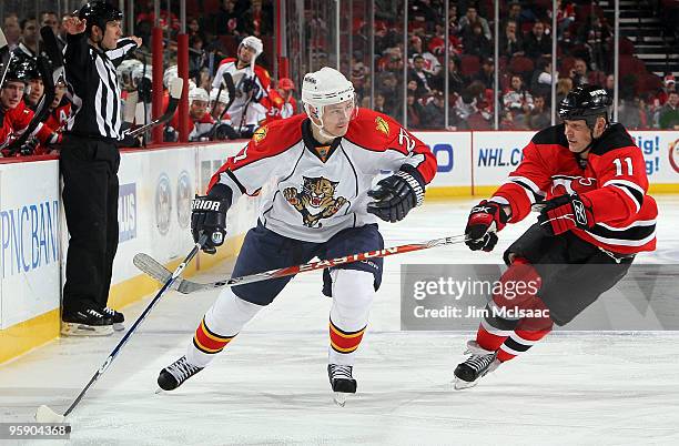 Steven Reinprecht of the Florida Panthers skates against Dean McAmmond of the New Jersey Devils at the Prudential Center on January 20, 2010 in...