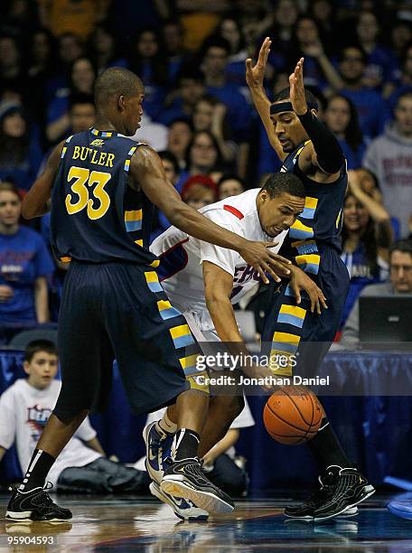 Mike Stovall of the DePaul Blue Demons moves between Jimmy Butler and Lazar Hayward of the Marquette Golden Eagles at the Allstate Arena on January...