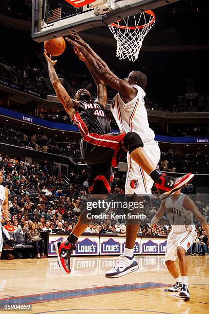 DeSagana Diop of the Charlotte Bobcats blocks against Udonis Haslem of the Miami Heat on January 20, 2010 at the Time Warner Cable Arena in...