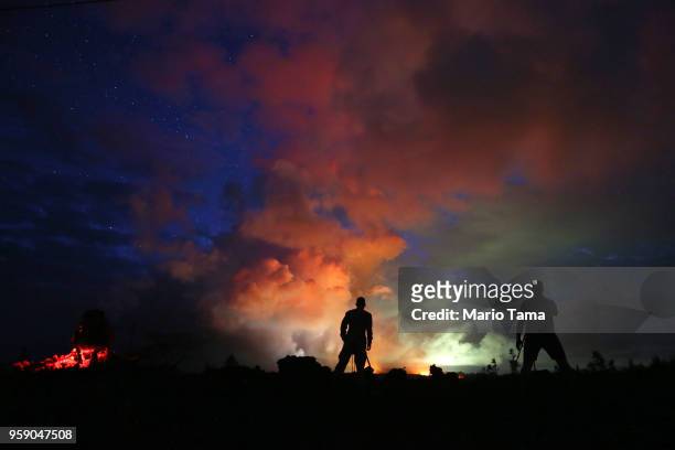 Photographers work as lava from active fissures illuminates volcanic gases from the Kilauea volcano on Hawaii's Big Island on May 15, 2018 in Hawaii...