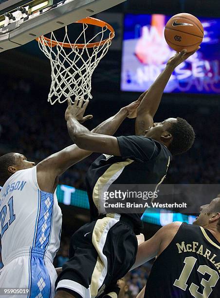 Al-Farouq Aminu of the Wake Forest Demon Deacons shots over the out stretched arm of Deon Thompson of the North Carolina Tar Heels on January 20,...