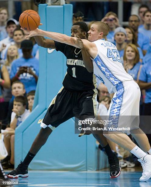 Travis Wear of the North Carolina Tar Heels gets called for a reach in foul against Al-Farouq Aminu of the Wake Forest Demon Deacons on January 20,...