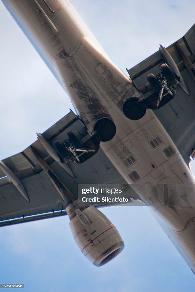 Underside of Commercial Jet Passing Low Overhead, London, England