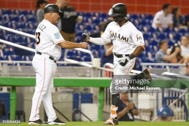 Lewis Brinson of the Miami Marlins celebrates with Fredi Gonzalez of the Miami Marlins after hitting a solo home run in the ninth inning against the...