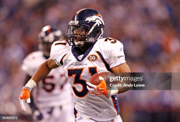 Darcel McBath of the Denver Broncos runs with the ball after intercepting a pass during the NFL game against the Indianapolis Colts at Lucas Oil...