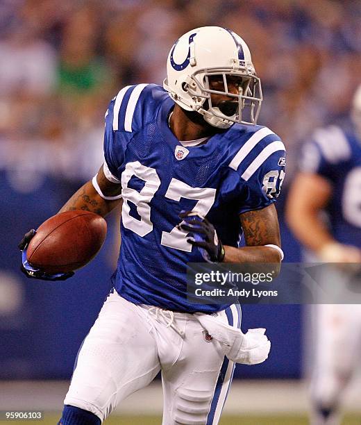 Reggie Wayne of the Indianapolis Colts runs with the ball during the NFL game against the Denver Broncos at Lucas Oil Stadium on December 13, 2009 in...