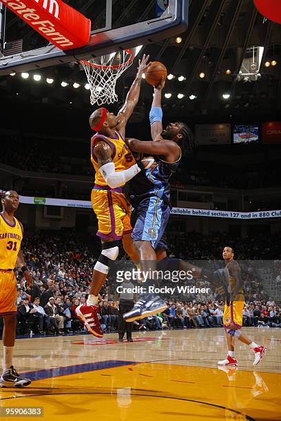 Nene Hilario of the Denver Nuggets finishes and is fouled by Corey Maggette of the Golden State Warriors on January 20, 2010 at Oracle Arena in...