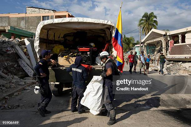 In this handout image provided by the United Nations Stabilization Mission in Haiti , Colombian search and rescue workers unload body bags January...