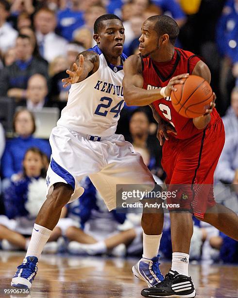 Eric Bledsoe of the Kentucky Wildcats defends Preston Knowles of the Louisville Cardinals at Rupp Arena on January 2, 2010 in Lexington, Kentucky....