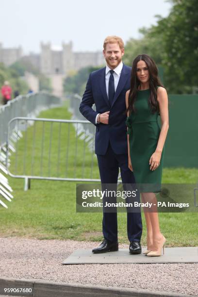 Madame Tussauds' wax figures of Prince Harry and Meghan Markle are paraded along the Long Walk in Windsor ahead of the royal wedding this weekend.